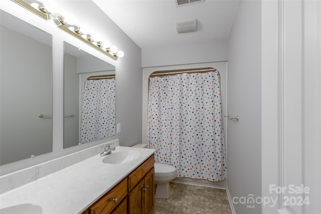 bathroom with toilet, a textured ceiling, a shower with curtain, and vanity