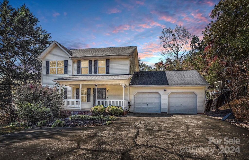 front of property with covered porch and a garage