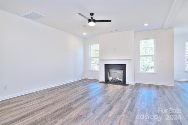 unfurnished living room featuring ceiling fan and light hardwood / wood-style flooring