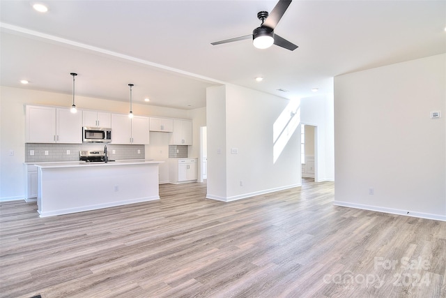 unfurnished living room featuring ceiling fan and light hardwood / wood-style flooring