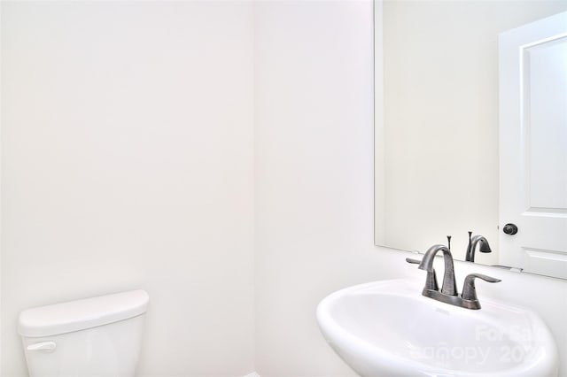 bathroom featuring toilet and sink