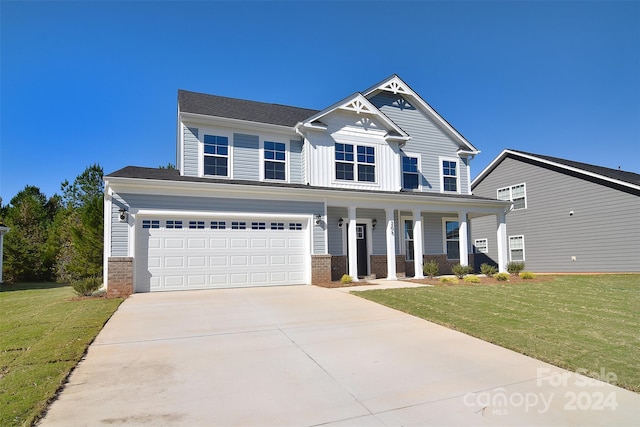 craftsman house with a porch, a front lawn, and a garage