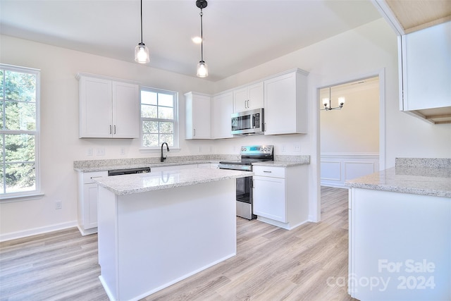 kitchen featuring white cabinets, stainless steel appliances, and plenty of natural light