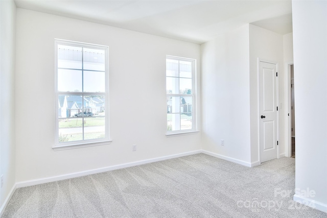 carpeted empty room featuring a healthy amount of sunlight