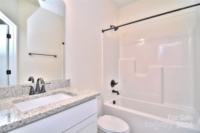 full bathroom featuring bathtub / shower combination, vanity, and toilet