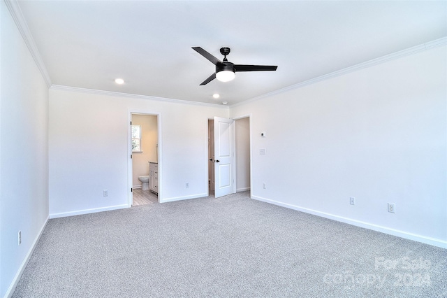 unfurnished bedroom featuring connected bathroom, crown molding, light carpet, and ceiling fan