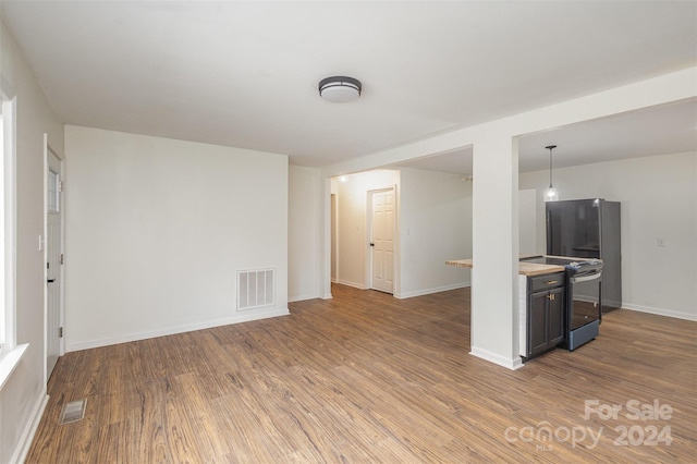 unfurnished living room with hardwood / wood-style floors