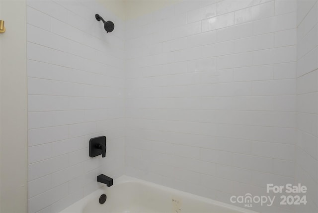 interior details featuring tiled shower / bath