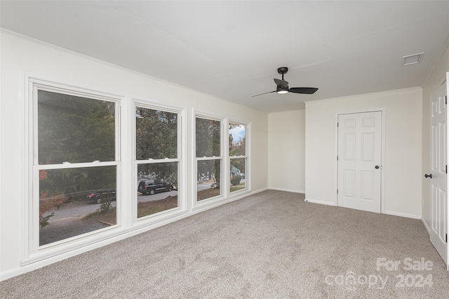 interior space with light colored carpet and ceiling fan