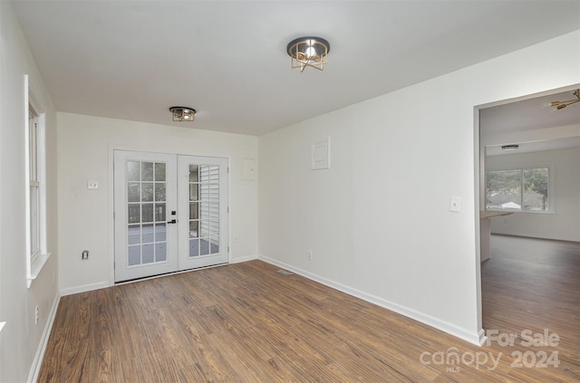 spare room featuring hardwood / wood-style floors and french doors