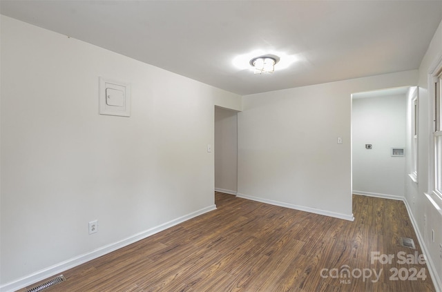 unfurnished room with dark hardwood / wood-style floors