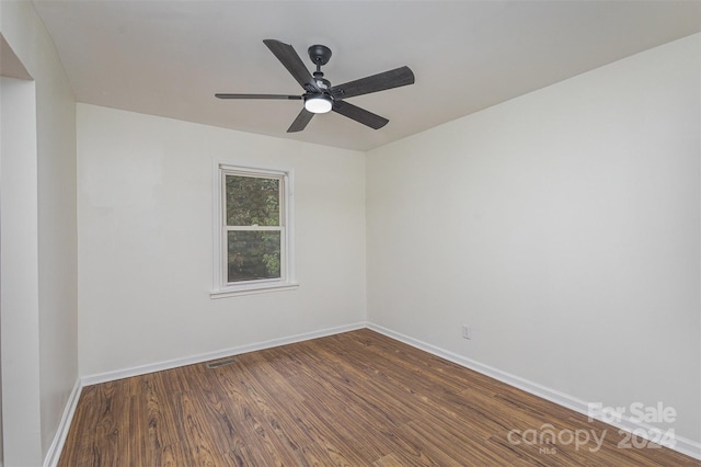 empty room featuring ceiling fan and dark hardwood / wood-style flooring