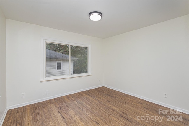 spare room with hardwood / wood-style floors