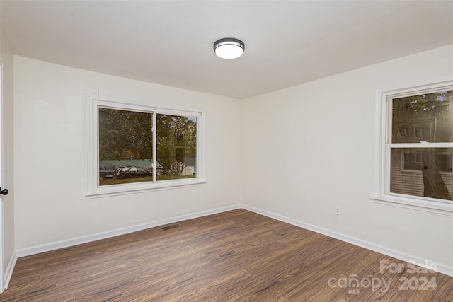 spare room with dark wood-type flooring