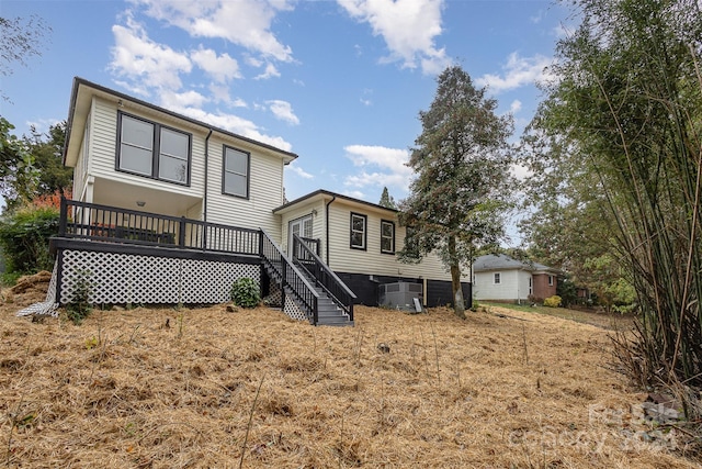 back of property with central AC and a wooden deck