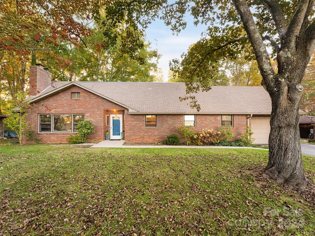 ranch-style house featuring a garage and a front lawn