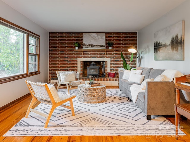 living room featuring light hardwood / wood-style floors and a wood stove