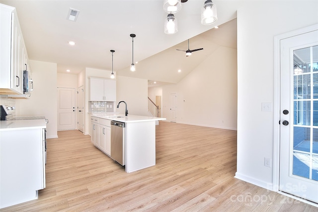 kitchen with stainless steel appliances, a center island with sink, pendant lighting, white cabinetry, and tasteful backsplash