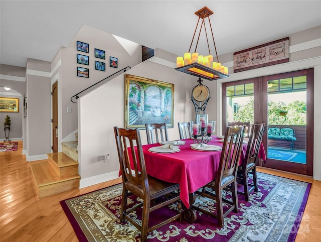 dining room with french doors and light hardwood / wood-style floors