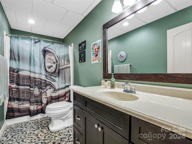 bathroom with vanity, a shower with curtain, toilet, and tile patterned floors