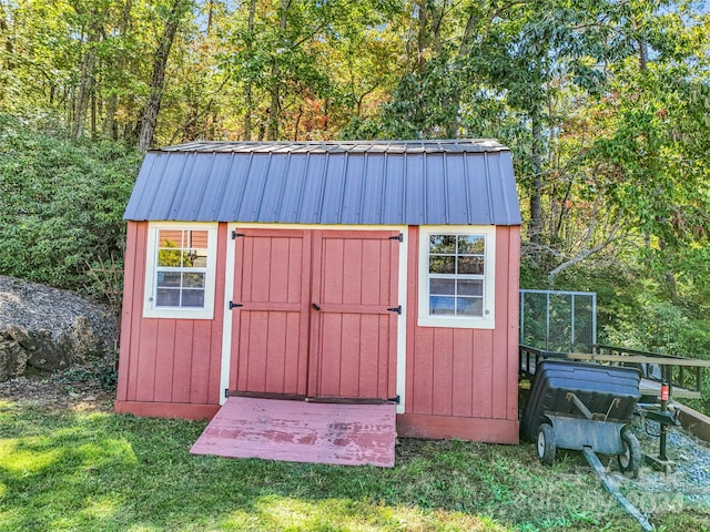 view of outbuilding featuring a yard