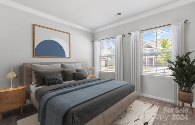 bedroom featuring light colored carpet, multiple windows, and crown molding