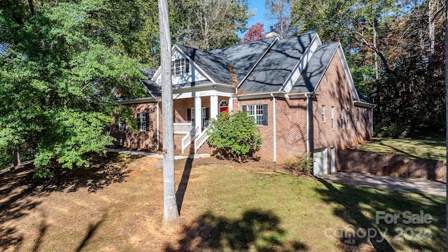 view of front of house with brick siding and a front lawn