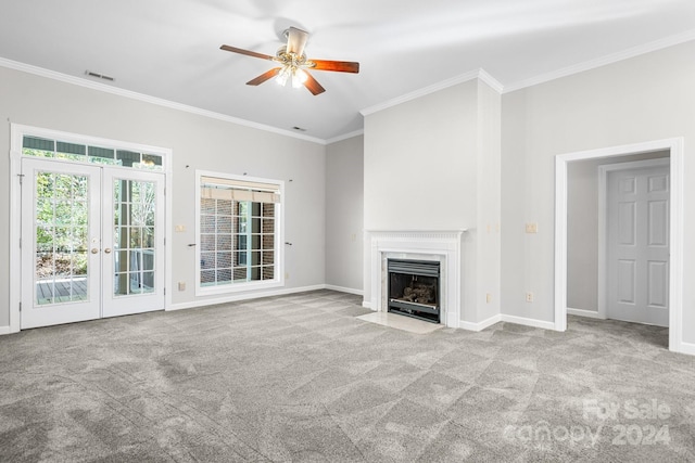 unfurnished living room featuring ceiling fan, french doors, visible vents, crown molding, and carpet flooring