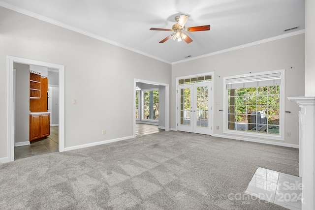 unfurnished living room featuring light carpet, french doors, ornamental molding, and plenty of natural light