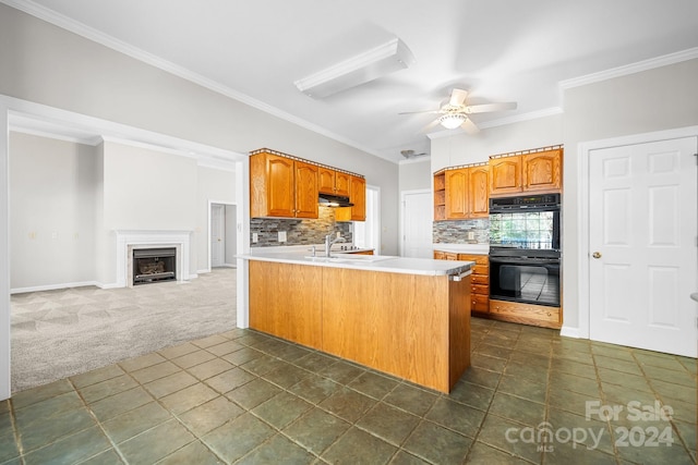 kitchen featuring tasteful backsplash, ceiling fan, dark carpet, ornamental molding, and black double oven