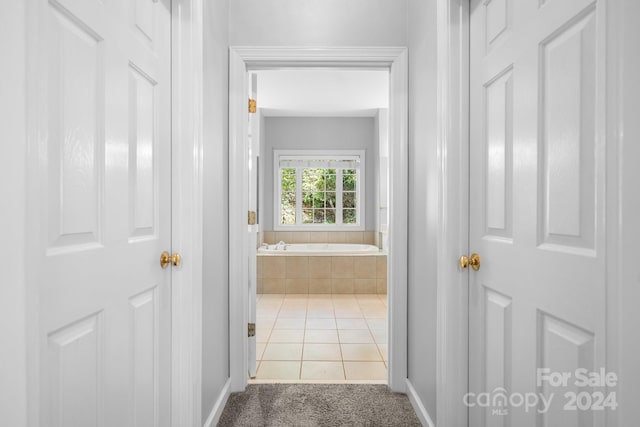 hall with light tile patterned floors