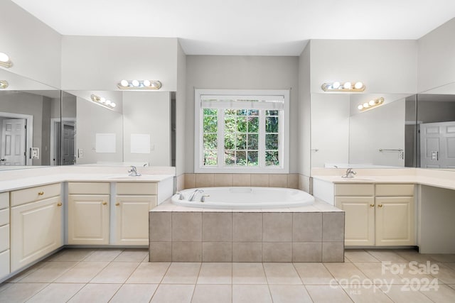 bathroom with vanity, tiled tub, and tile patterned floors