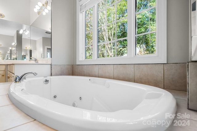 bathroom with vanity, a whirlpool tub, and a wealth of natural light