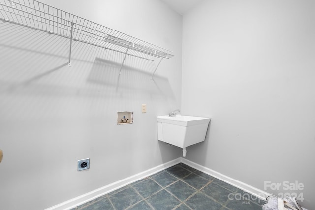 laundry room with washer hookup, laundry area, electric dryer hookup, dark tile patterned flooring, and baseboards