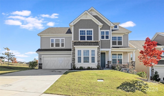 craftsman inspired home with a front yard and a garage