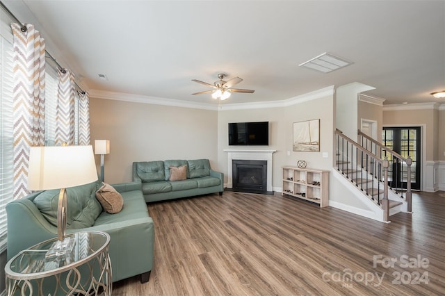 living room featuring wood-type flooring, ceiling fan, and crown molding