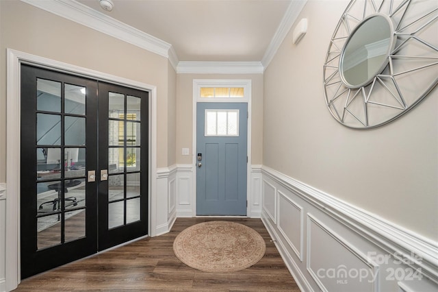 entrance foyer with ornamental molding, french doors, and dark hardwood / wood-style flooring