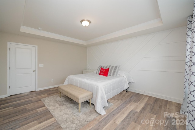 3057 Burnello Ct, Iron Station, NC 28080 - bedroom featuring a raised ceiling, crown molding, wood finished floors, and baseboards