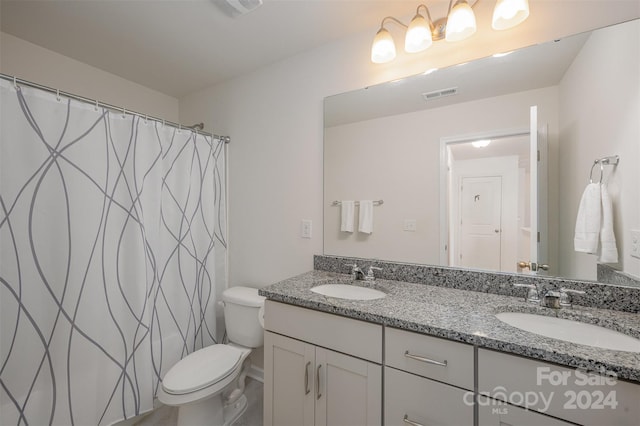 bathroom with a shower with shower curtain, vanity, and toilet