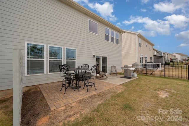 rear view of house featuring a yard and a patio area