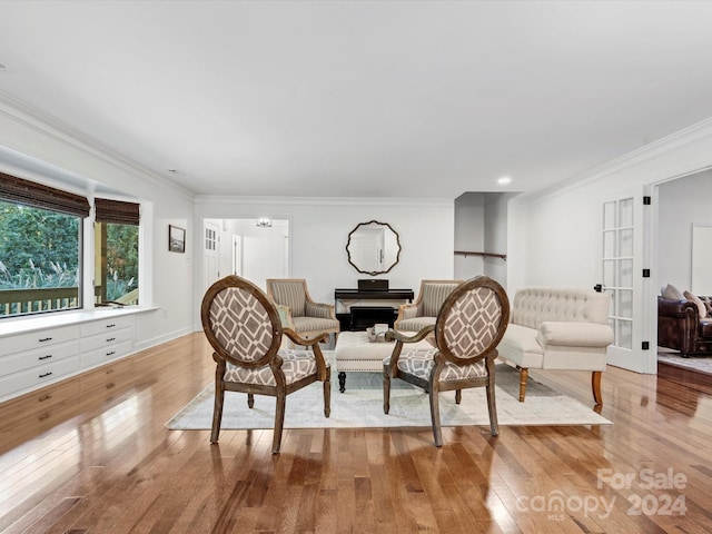 living room featuring french doors, crown molding, and light hardwood / wood-style flooring