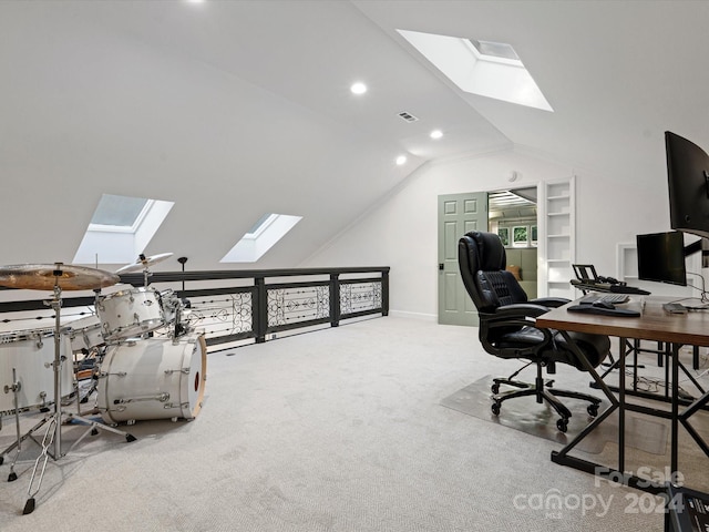 carpeted office space featuring vaulted ceiling with skylight and a healthy amount of sunlight