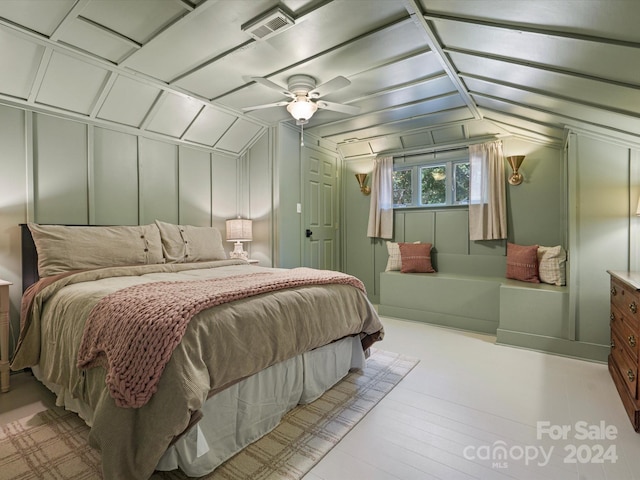 bedroom with light wood-type flooring, vaulted ceiling, and ceiling fan