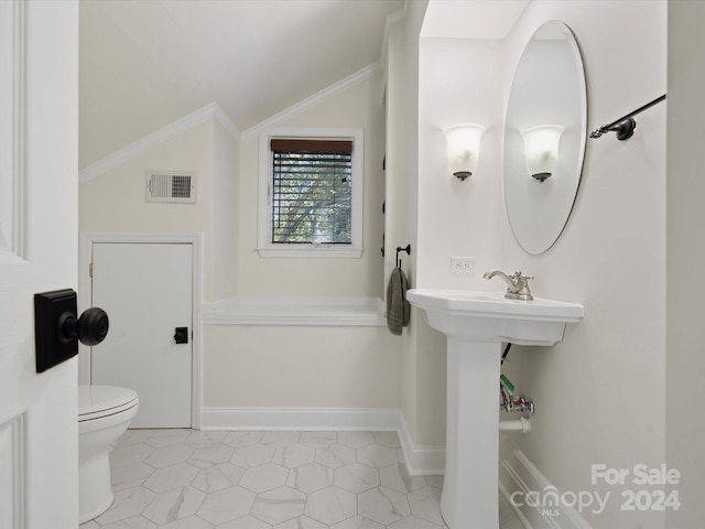 bathroom with toilet, ornamental molding, vaulted ceiling, and tile patterned flooring