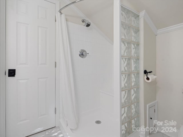 bathroom featuring crown molding and curtained shower