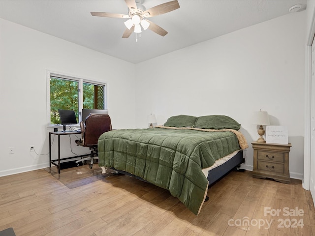 bedroom featuring hardwood / wood-style floors and ceiling fan