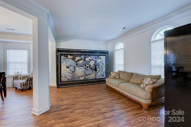 living room with wood-type flooring and ornamental molding