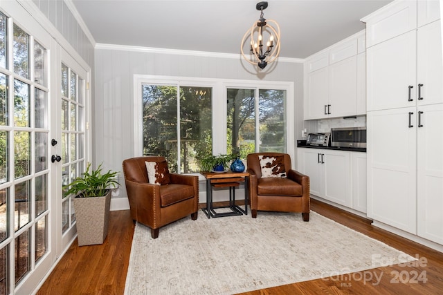 sitting room featuring dark hardwood / wood-style flooring, a healthy amount of sunlight, and ornamental molding