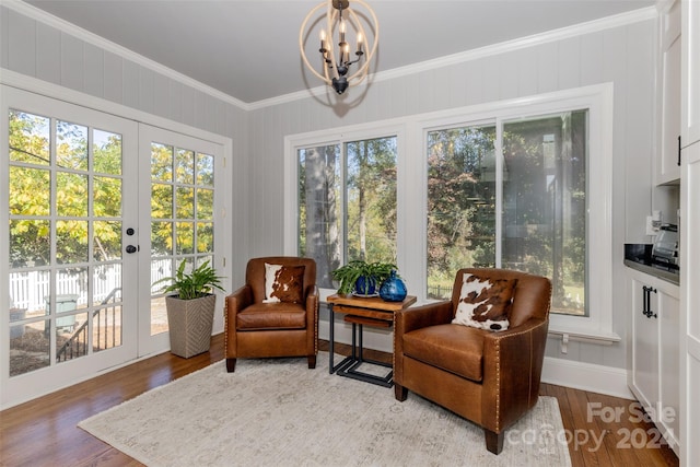 sunroom / solarium featuring an inviting chandelier, a wealth of natural light, and french doors