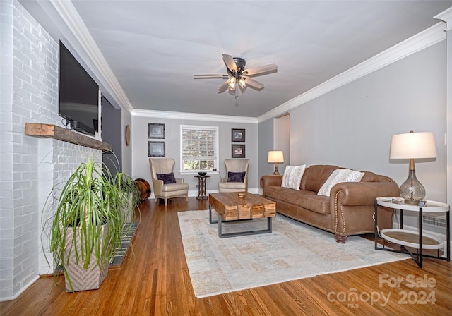 living room with hardwood / wood-style floors, ceiling fan, and ornamental molding